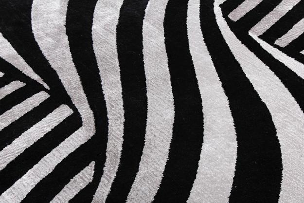Black and white zebra striped area rug close up view