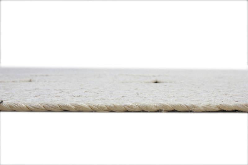 Close up view of white braided jute rug edge
