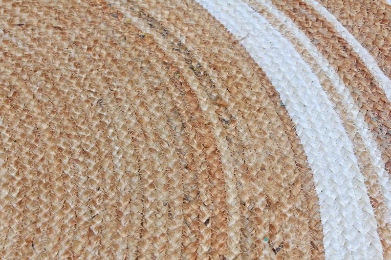 Close-up of the Luzione 915 Urban Rug, a round, striped jute rug. Handcrafted, eco-friendly, and perfect for adding bohemian style to your home
