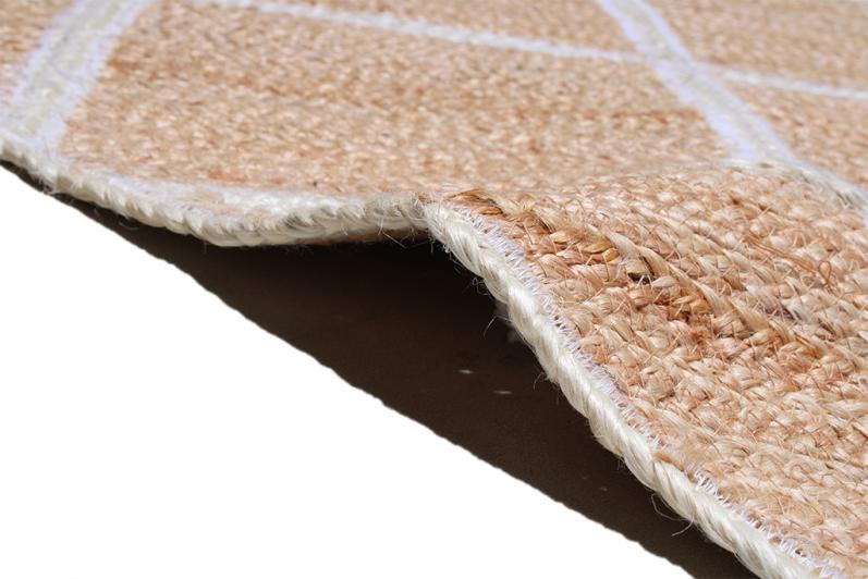Close up view of natural fiber rug with white diamond pattern