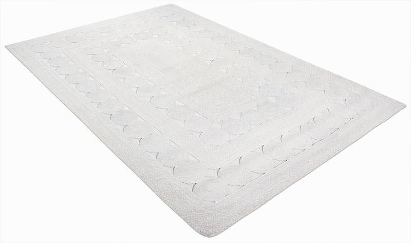 White rectangular rug with scalloped border pattern on white background