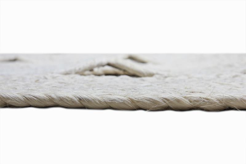 Close up view of white braided jute rug edge