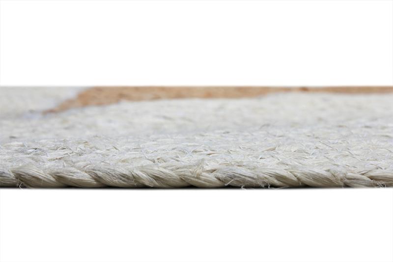 Close up view of braided white and tan area rug edge