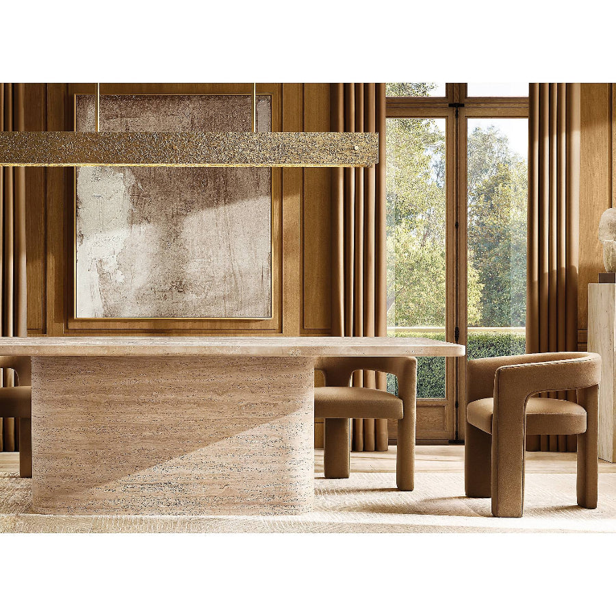 Interior view of a modern dining room featuring a Luzione Sukh travertine dining table and upholstered chairs, showcasing luxury interior design