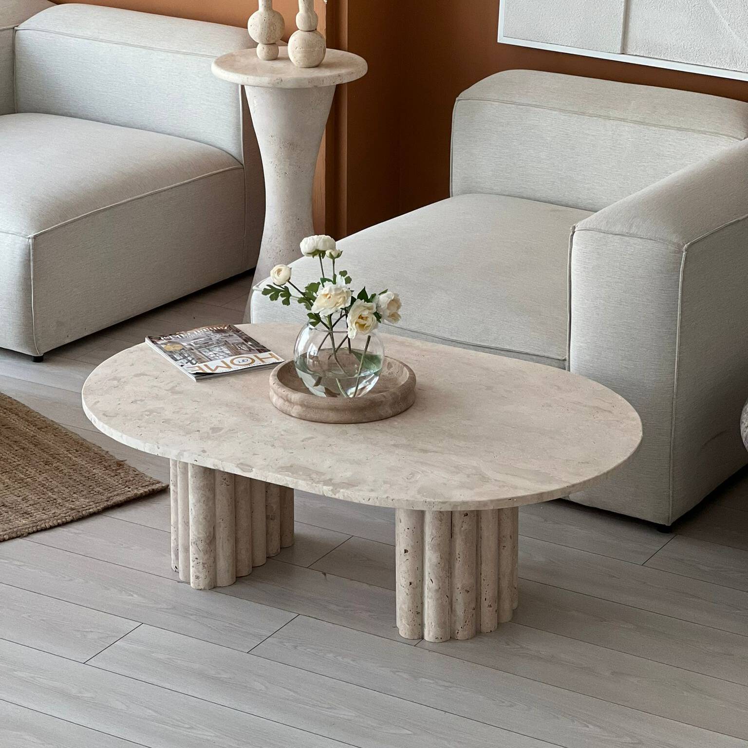 Luzione Crescent Travertine coffee table with oval top and cylindrical bases modern stone design