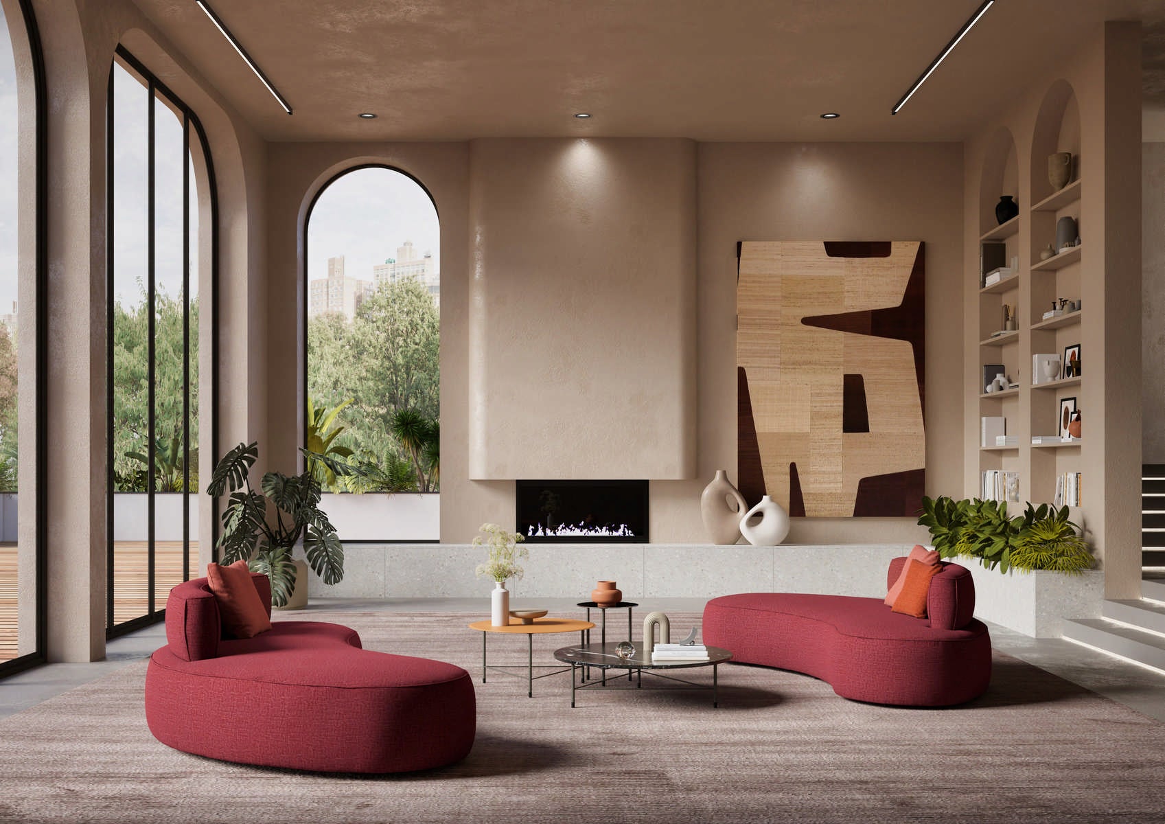 Interior view of living room with red curved chaise lounges, coffee tables, fireplace, and arched windows overlooking trees.