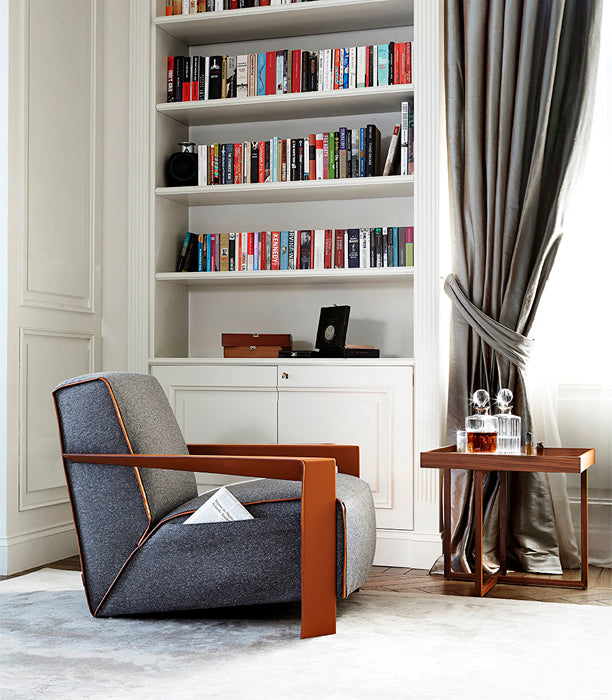 library reading nook, gray upholstered armchair, wood side table, white built-in bookcase
