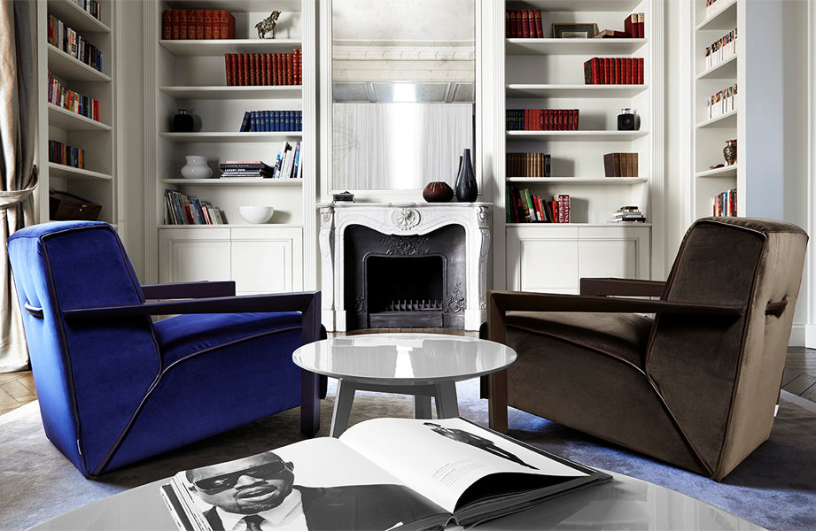 Living room with blue and brown velvet armchairs, white coffee table
