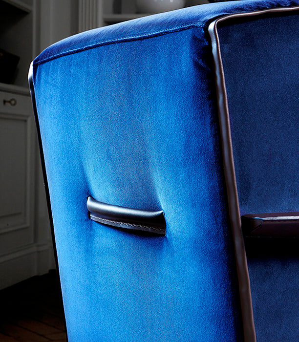 Close up blue velvet chair back leather handle