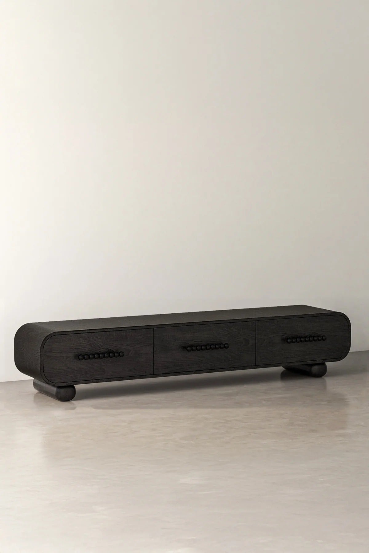 Black chestnut media console cabinet against a white wall and floor.