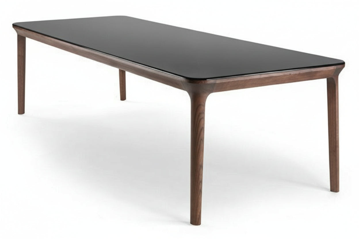 Dining table with wood frame and black glass top on white background