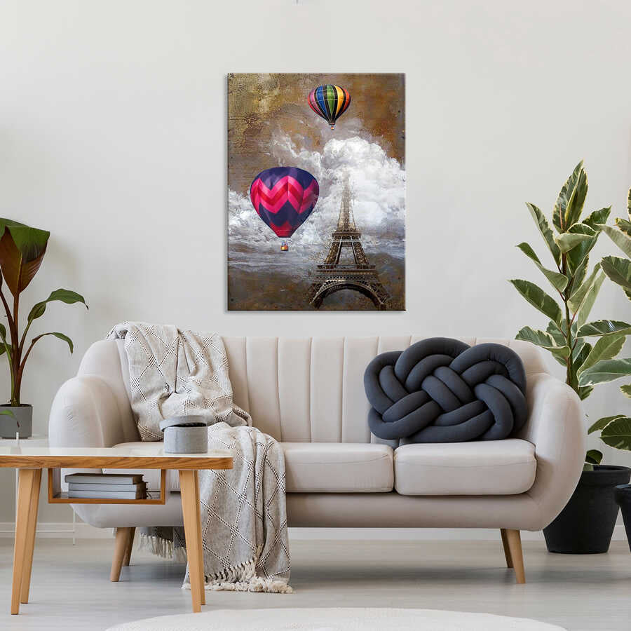 Living room with a couch, coffee table, and wall art of hot air balloons and the Eiffel Tower.