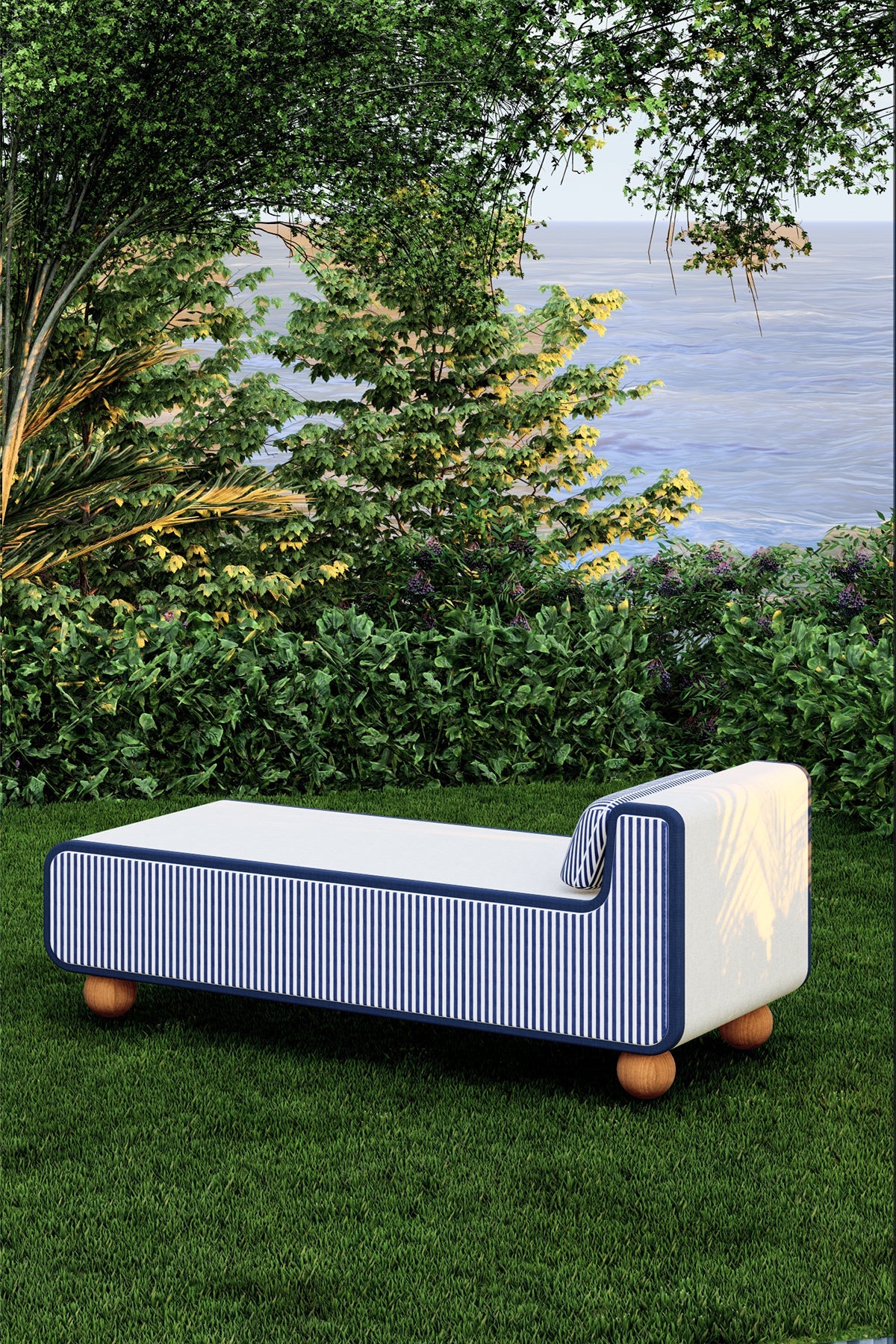 Modern outdoor sofa with striped design on grass near water