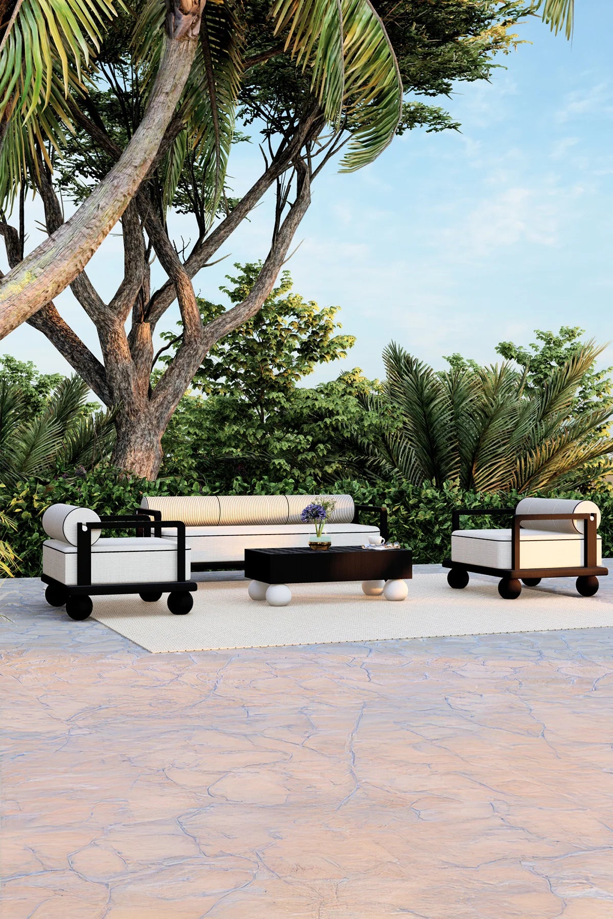 Outdoor patio with modern furniture set against a tropical backdrop