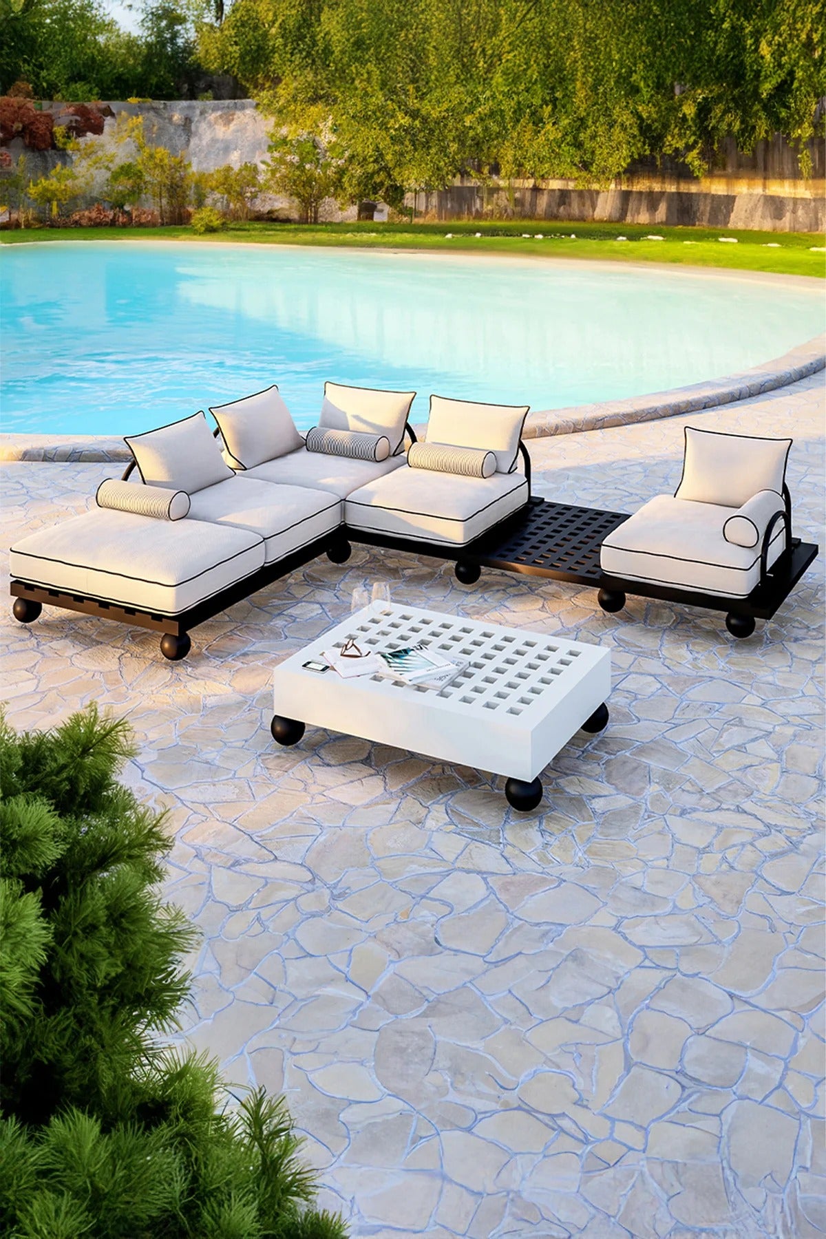 Outdoor patio furniture set by a pool with a stone patio and greenery.