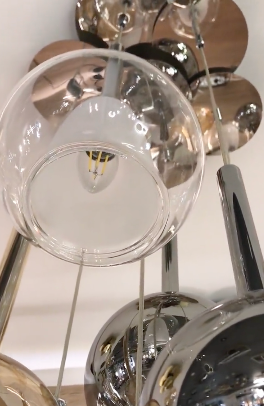 Close up view of clear glass globe chandelier lighting fixture