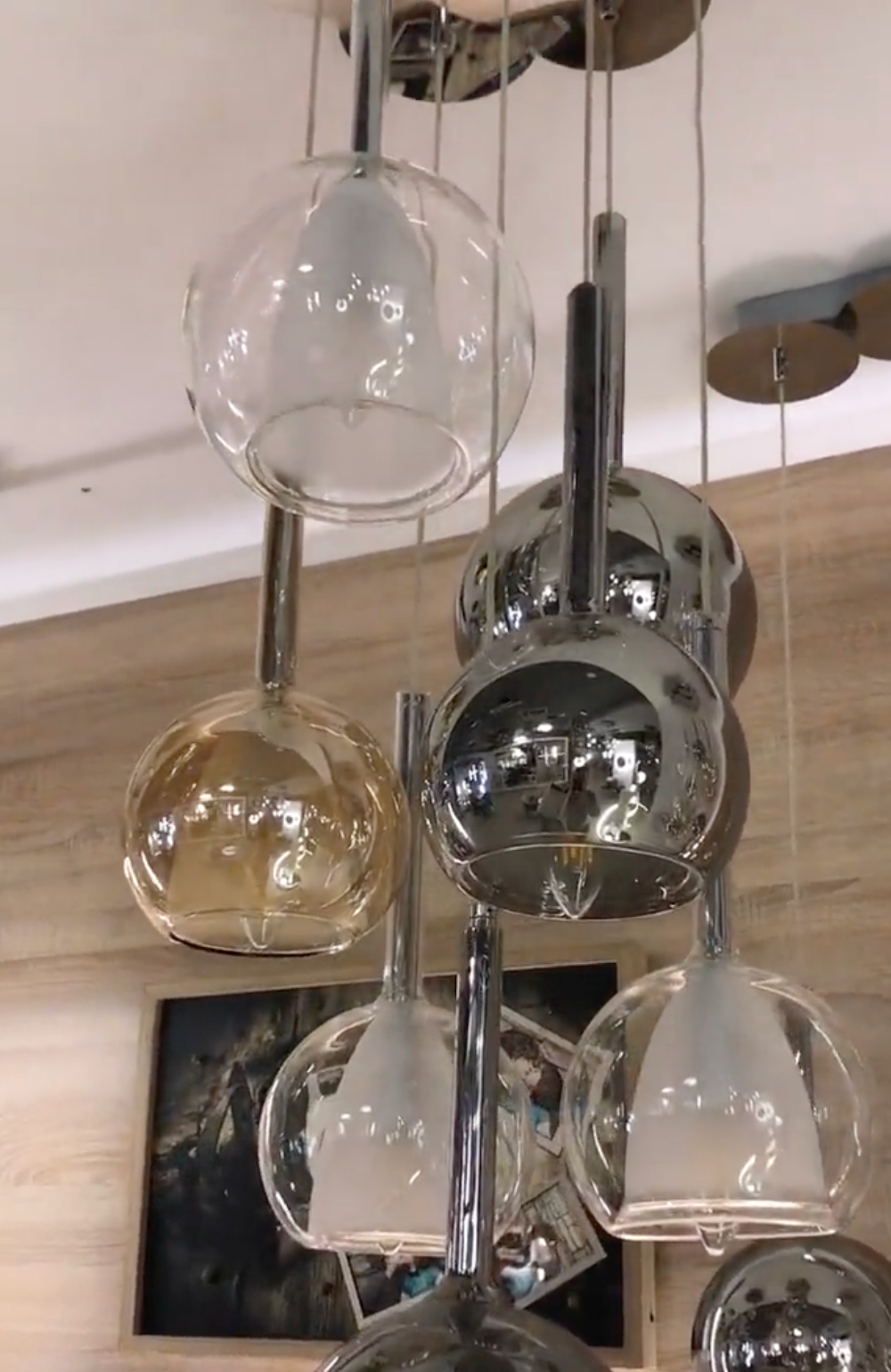 View of modern glass and chrome pendant lighting fixture.