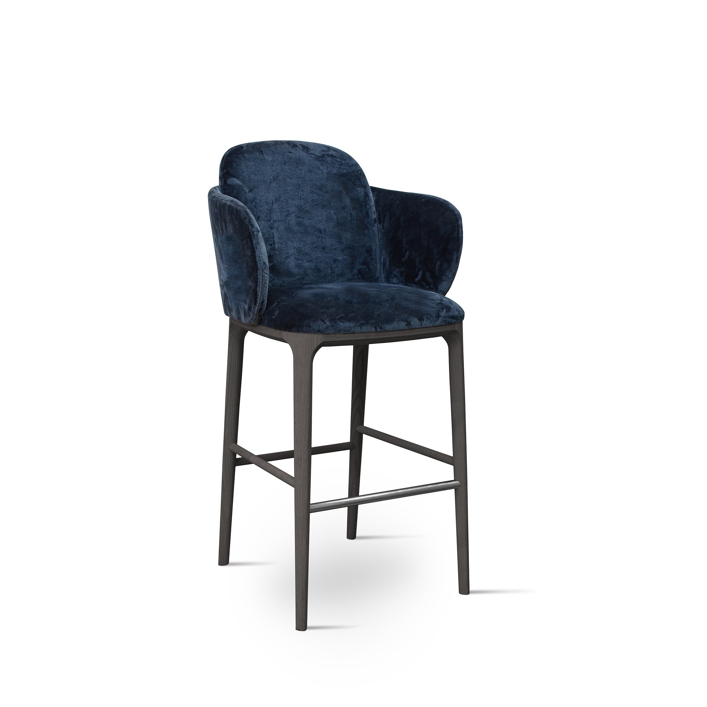 Studio shot of a blue velvet upholstered bar stool with wood legs.