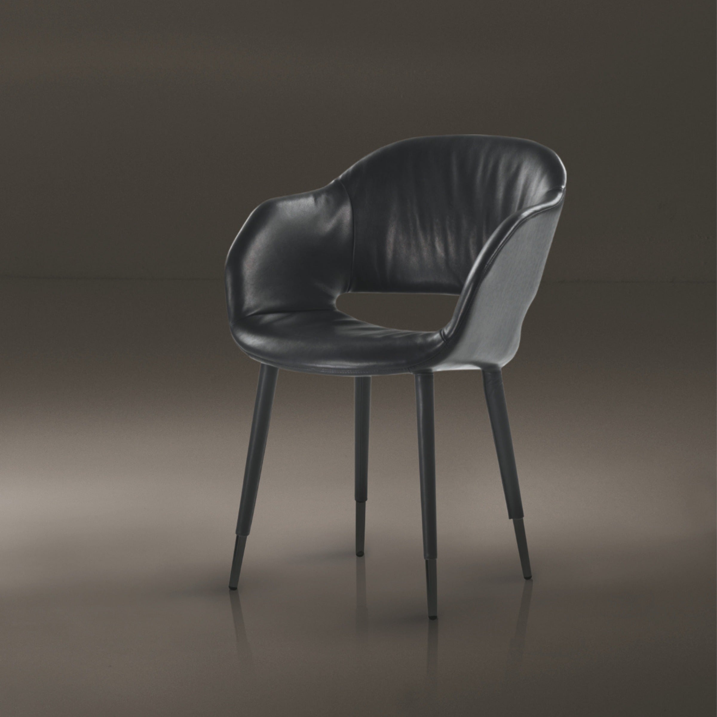 Studio shot of black leather dining chair on dark background furniture