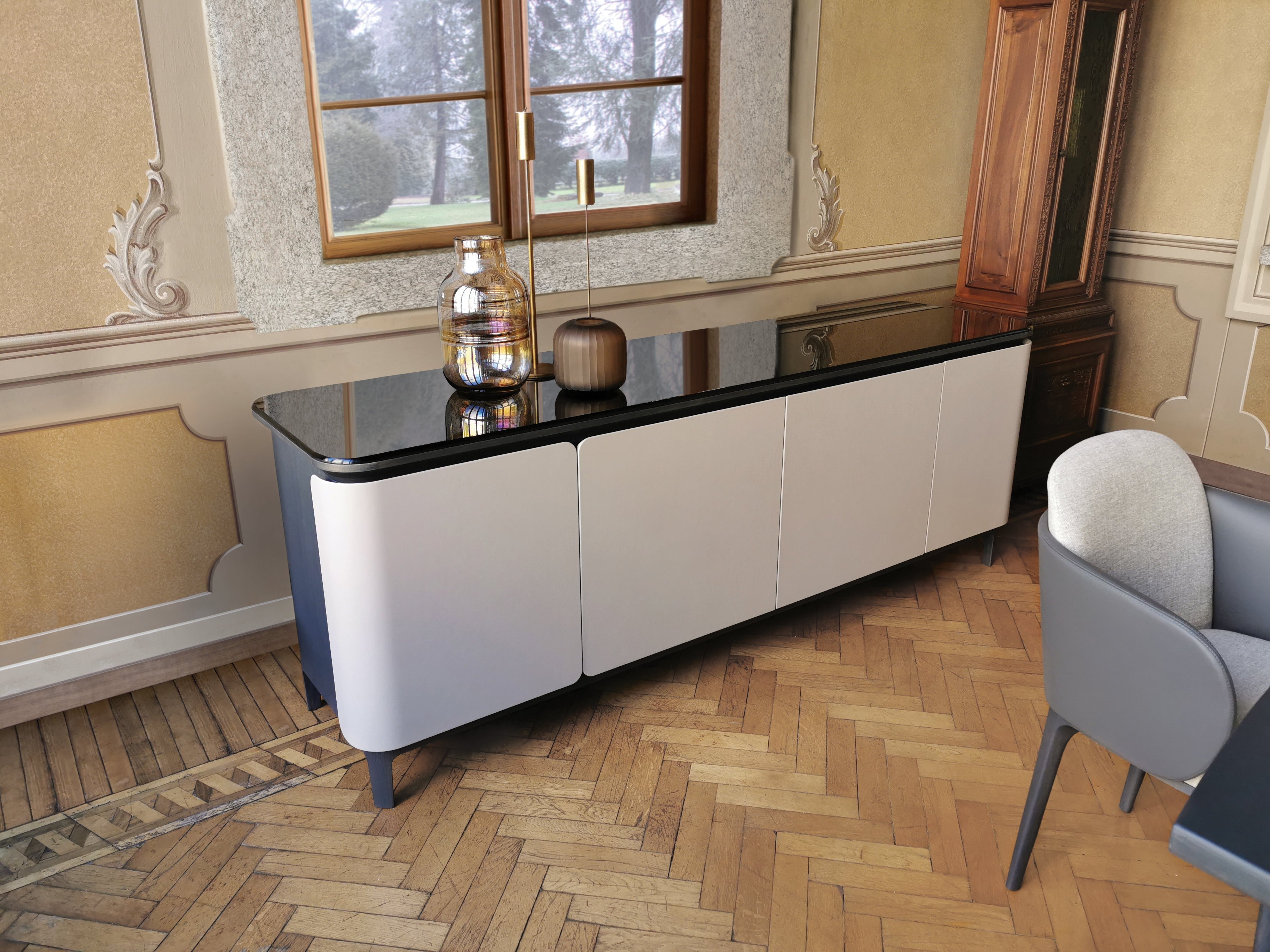 View of classic room with modern white sideboard, glass decor, wooden floor.