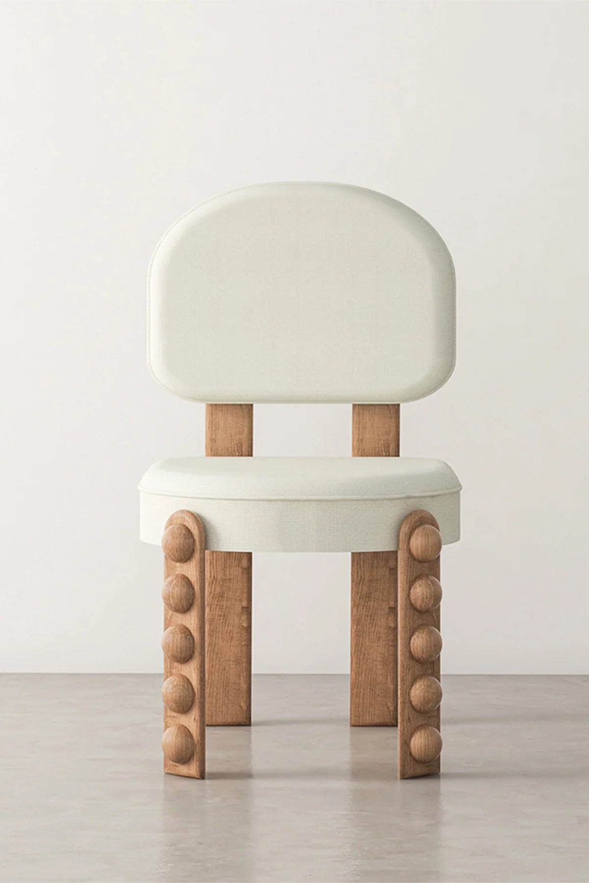 Modern upholstered dining chair with wood accents against white wall.