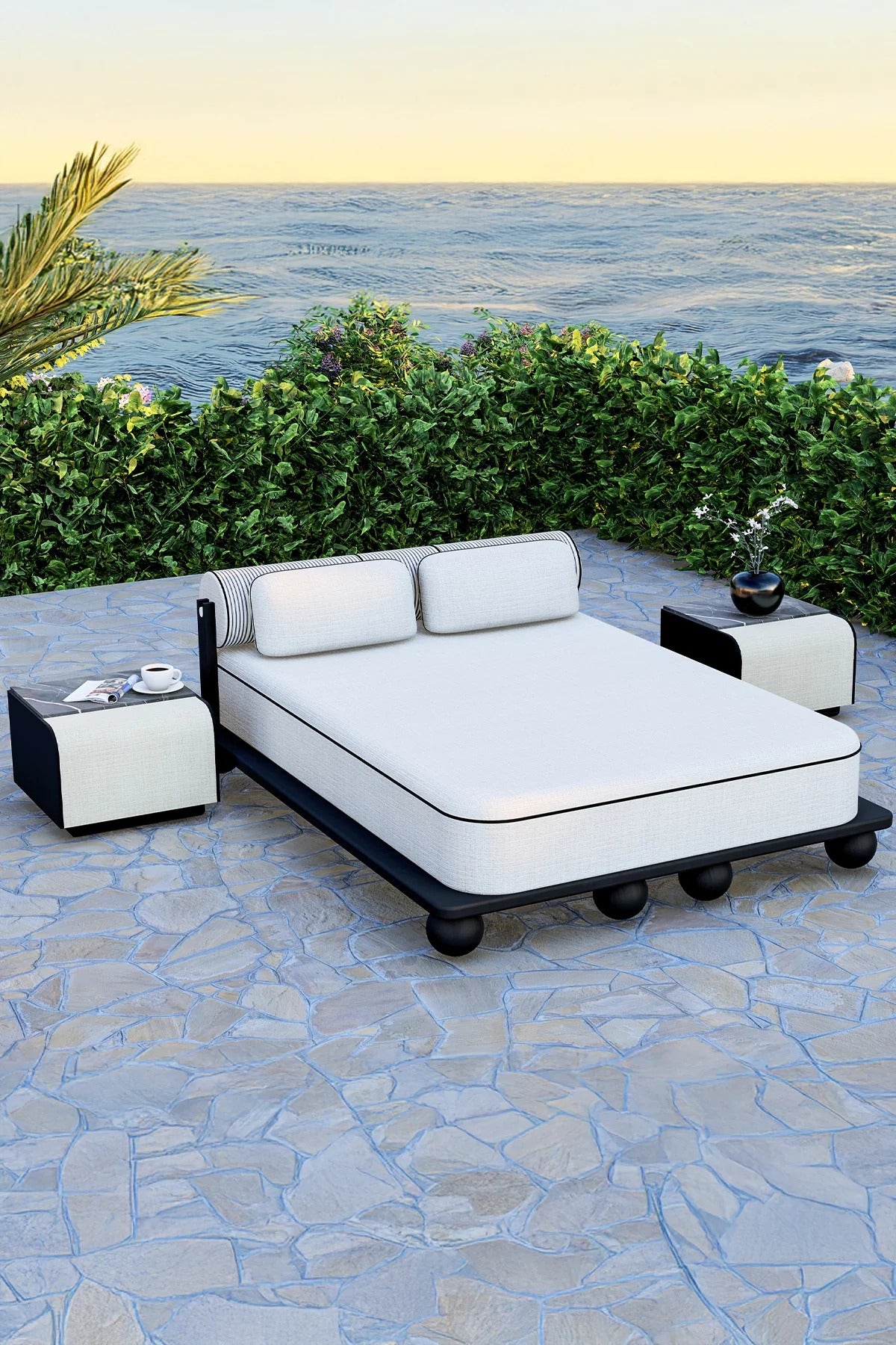 Tyrrhenian Double Daybed with rounded black sphere legs, white performance cushions, and modern outdoor luxury sunbed.