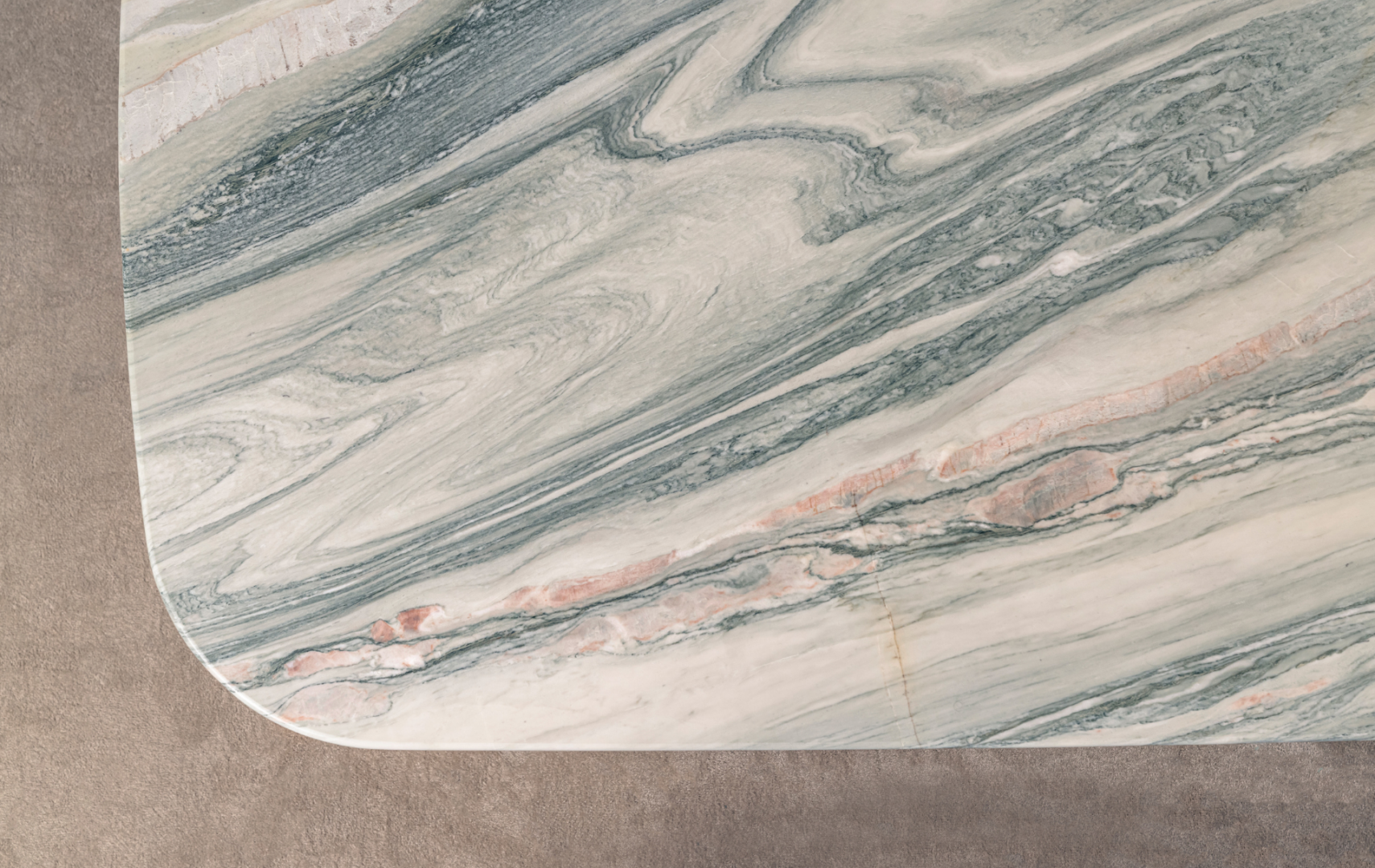Close up view of marble table top with green and pink veining