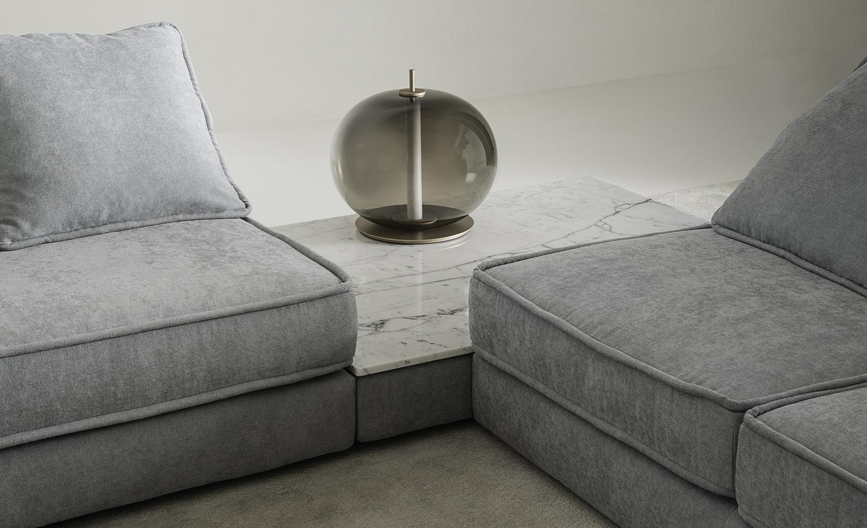  Modern living room featuring a light gray modular sofa, marble coffee table, and glass lamp. Perfect for contemporary living spaces.
