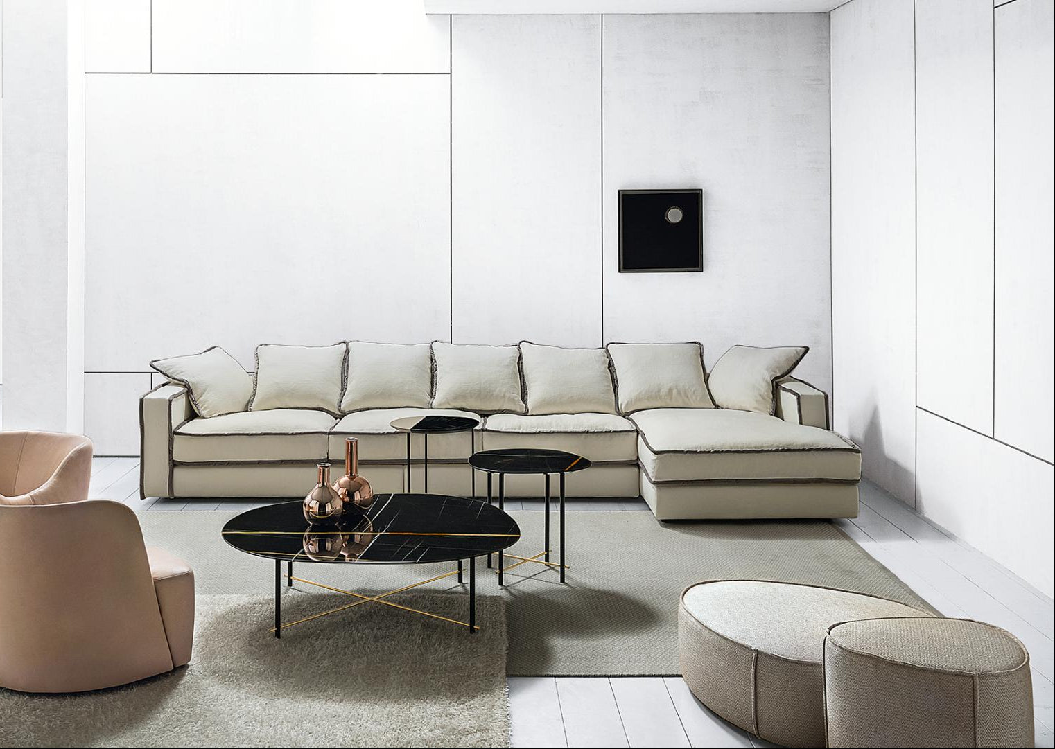  Modern living room featuring a sectional sofa, armchairs, and marble coffee tables.