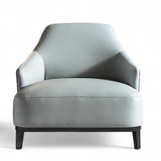 Light blue leather armchair next to bronze hexagonal side table