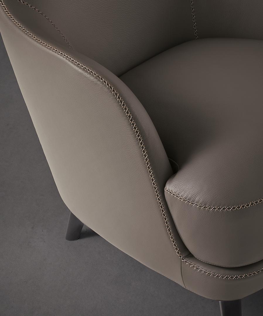 Close-up of the Casamilano Liz armchair showcasing its smooth leather texture and detailed stitching