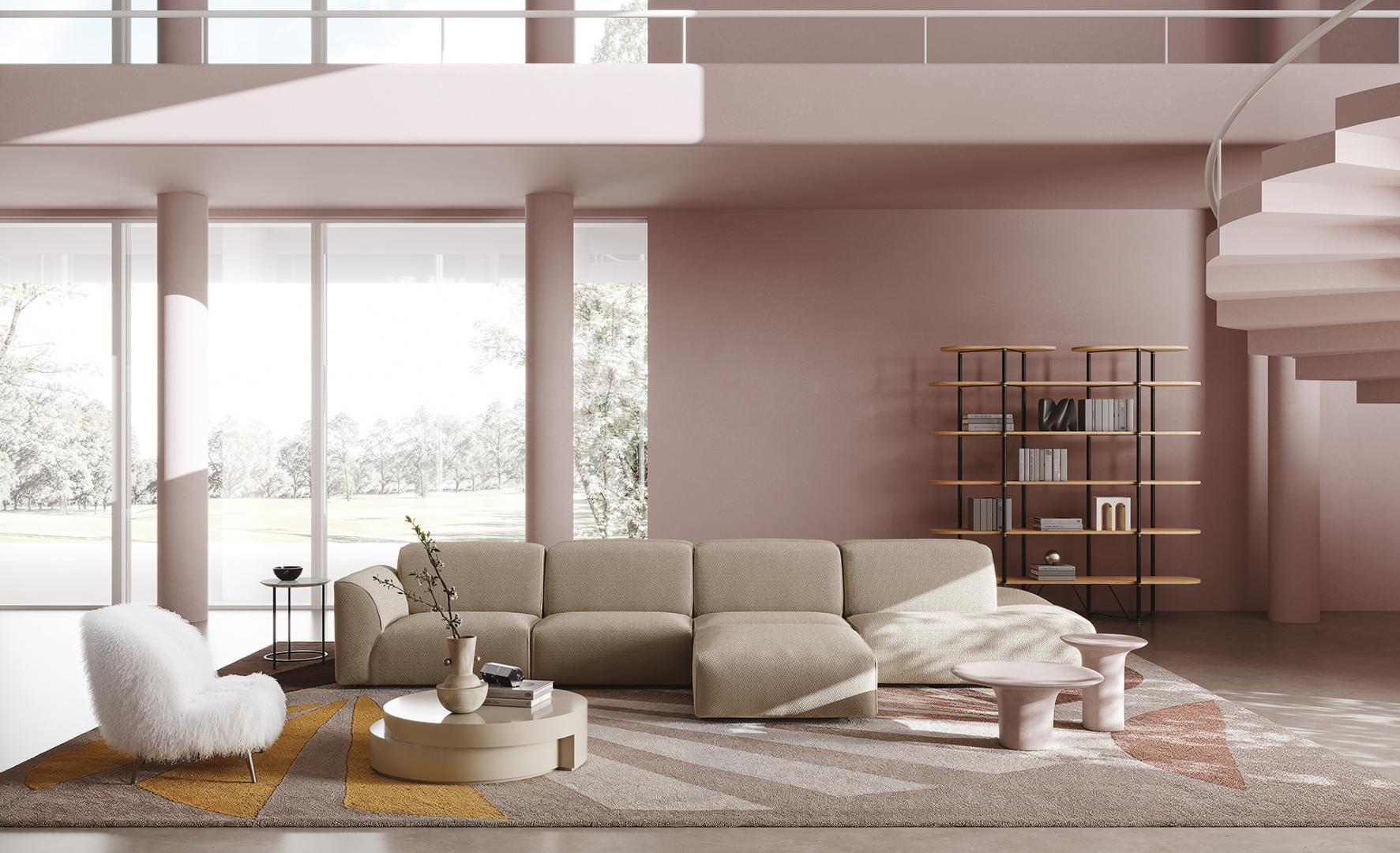 Interior of a pink modern living room with a modular sofa, fluffy chair, round coffee table, shelving unit, and a Casamilano Dhora Slim armchair