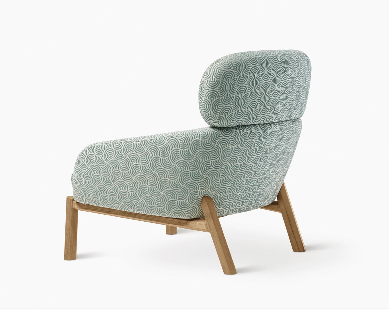 Back view of the Casamilano Elton armchair featuring patterned light blue and white upholstery and a solid wooden frame. Modern lounge chair for stylish home decor