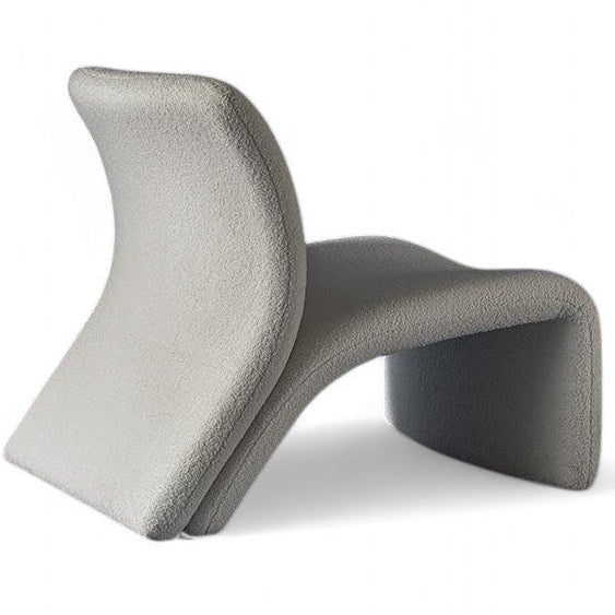 Gray curved upholstered chaise lounge on white background