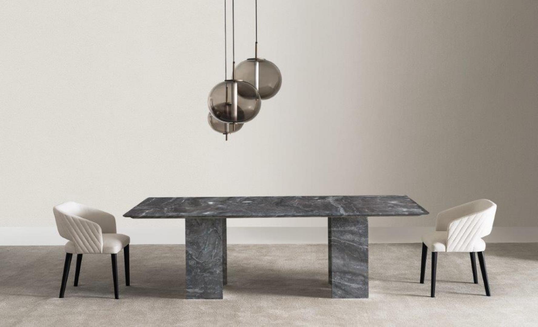  Modern dining room featuring a Casamilano Karl marble dining table, upholstered chairs, and globe pendant lights. Interior design