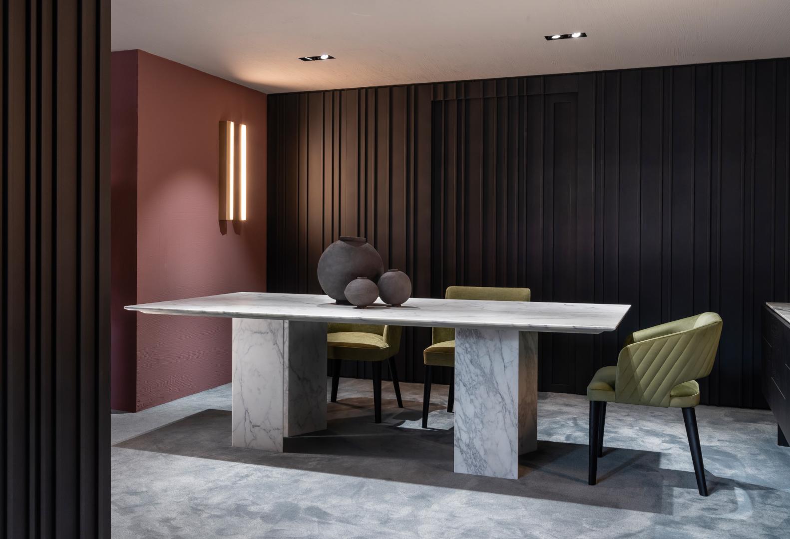 Modern dining room with marble table and green upholstered chairs, showcasing contemporary design and luxurious home decor