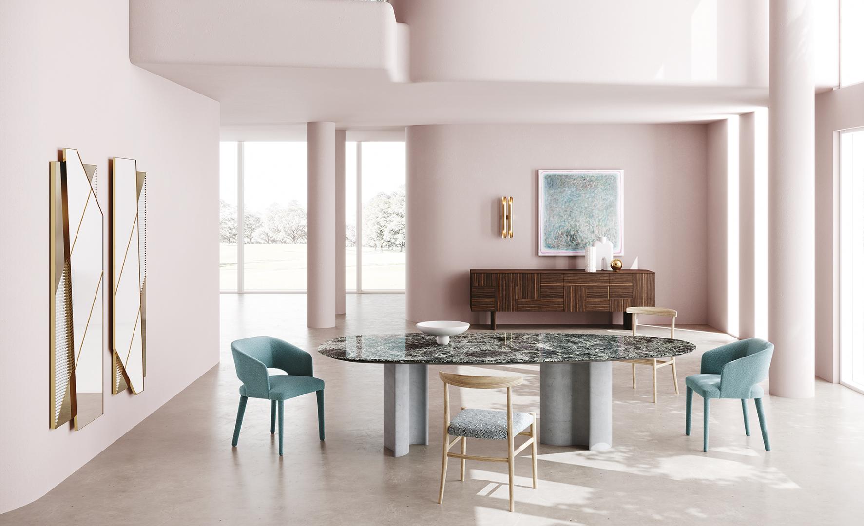 Interior of a modern dining room featuring a Casamilano Virgola IN & OUTDOOR dining table with marble top and concrete legs, surrounded by teal chairs