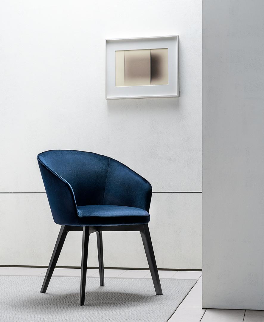  Interior with a blue velvet Shirley dining chair by Casamilano, offering a touch of luxury and sophisticated seating in a modern living space