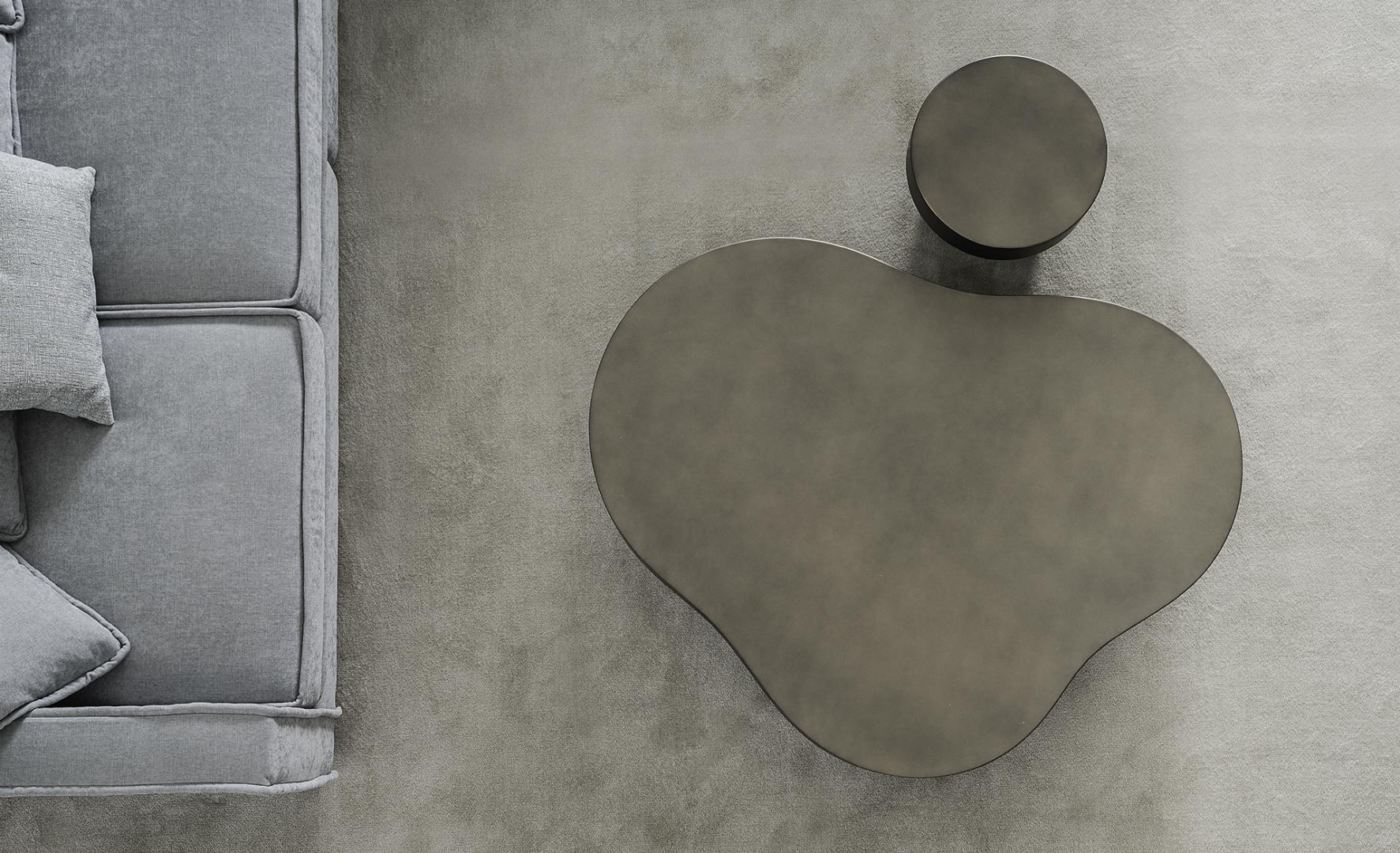 A top-down view of a modern living room featuring a Casamilano Nuvola coffee table, side table, and gray sofa.