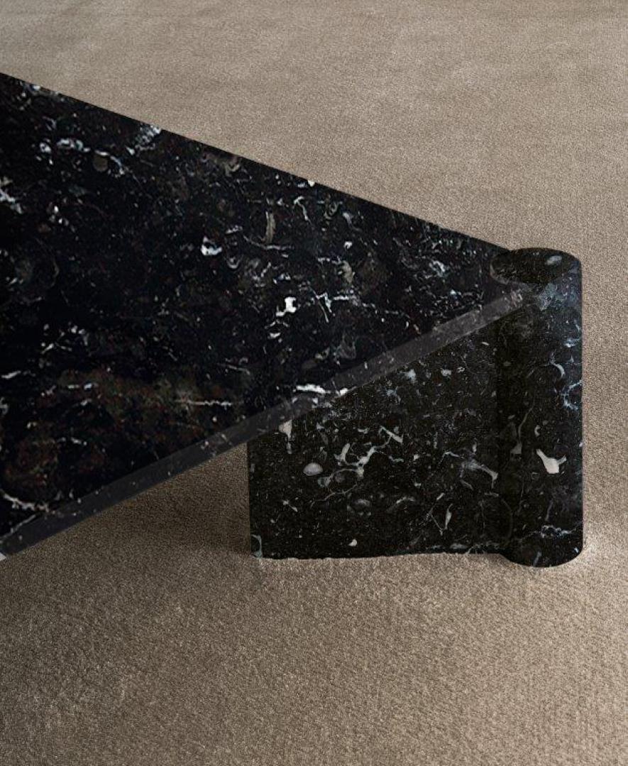 Close-up of a black marble side table with a geometric design, perfect as a luxury accent piece in a modern living space