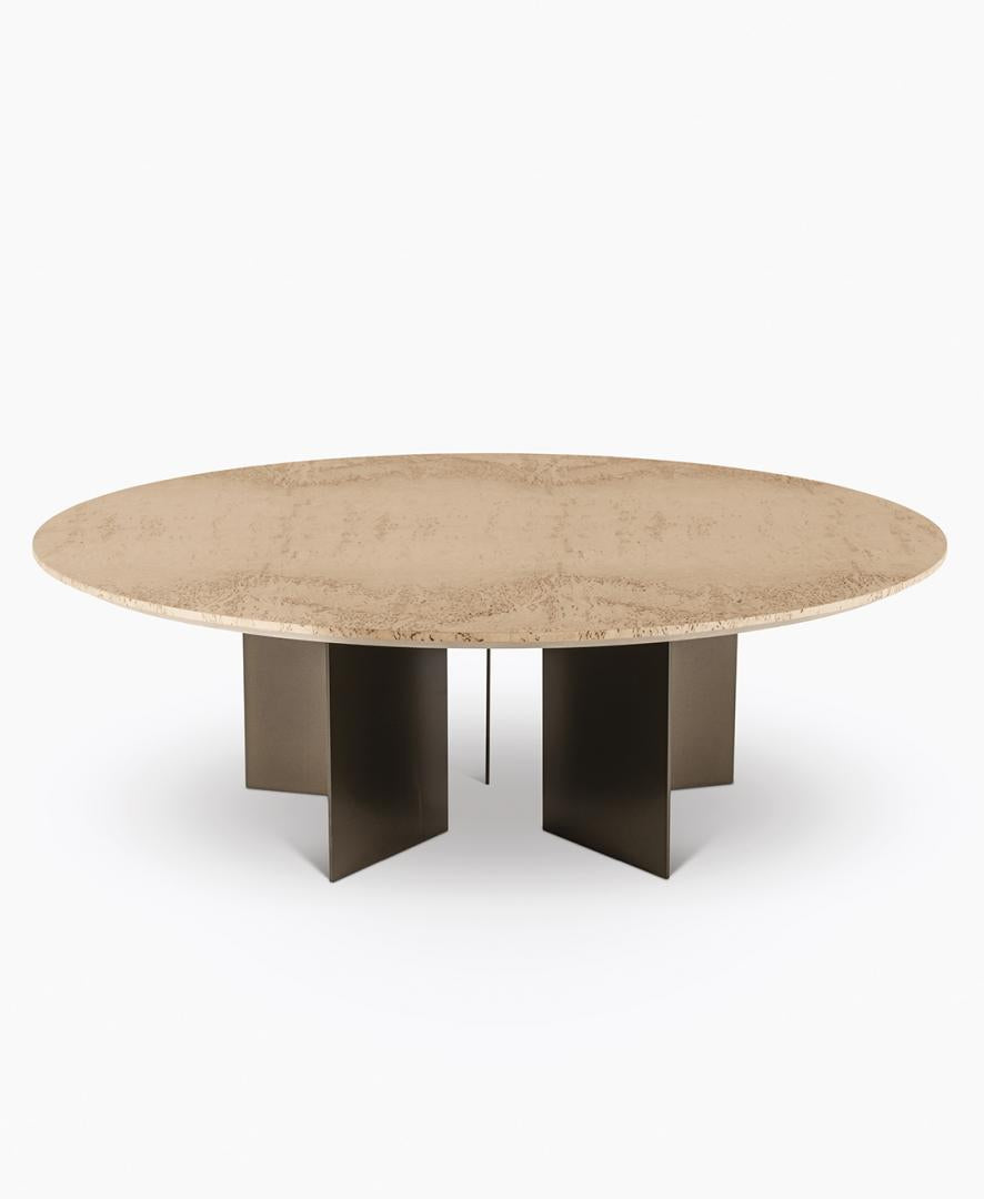  Eye-level studio shot of the Vito dining table by Casamilano, featuring a textured light brown top and a unique dark metal base.