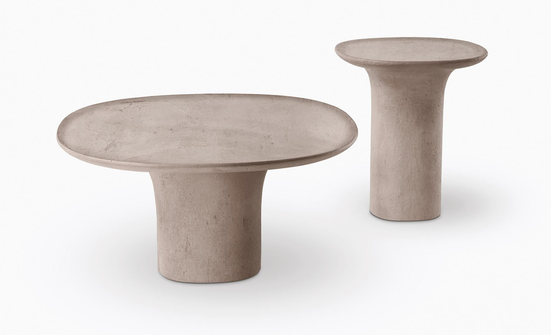  Studio shot of Casamilano Callas IN & OUTDOOR tables: modern concrete side tables with oval and round tops, minimalist design