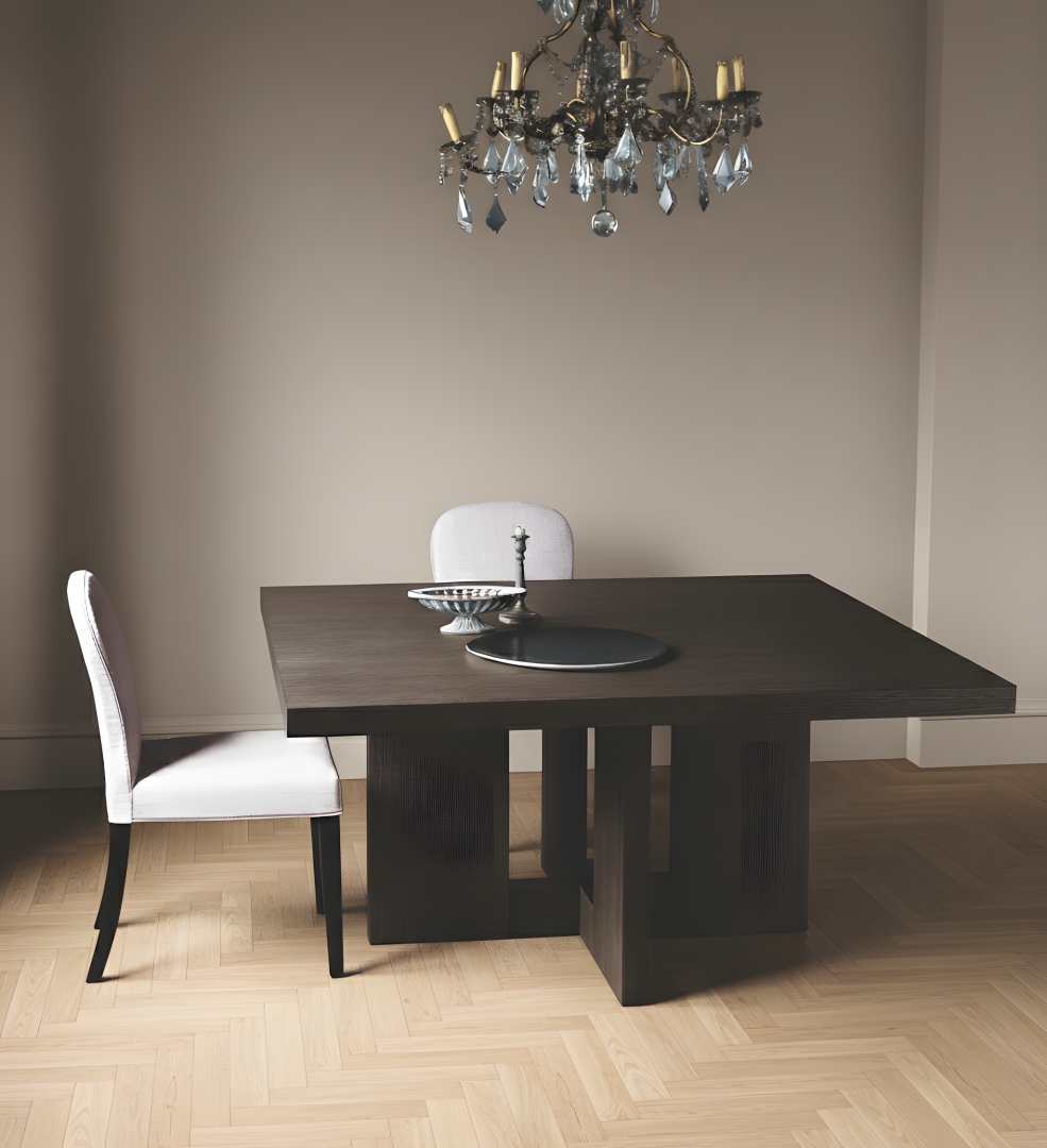 Dark wood dining table and chairs under crystal chandelier.