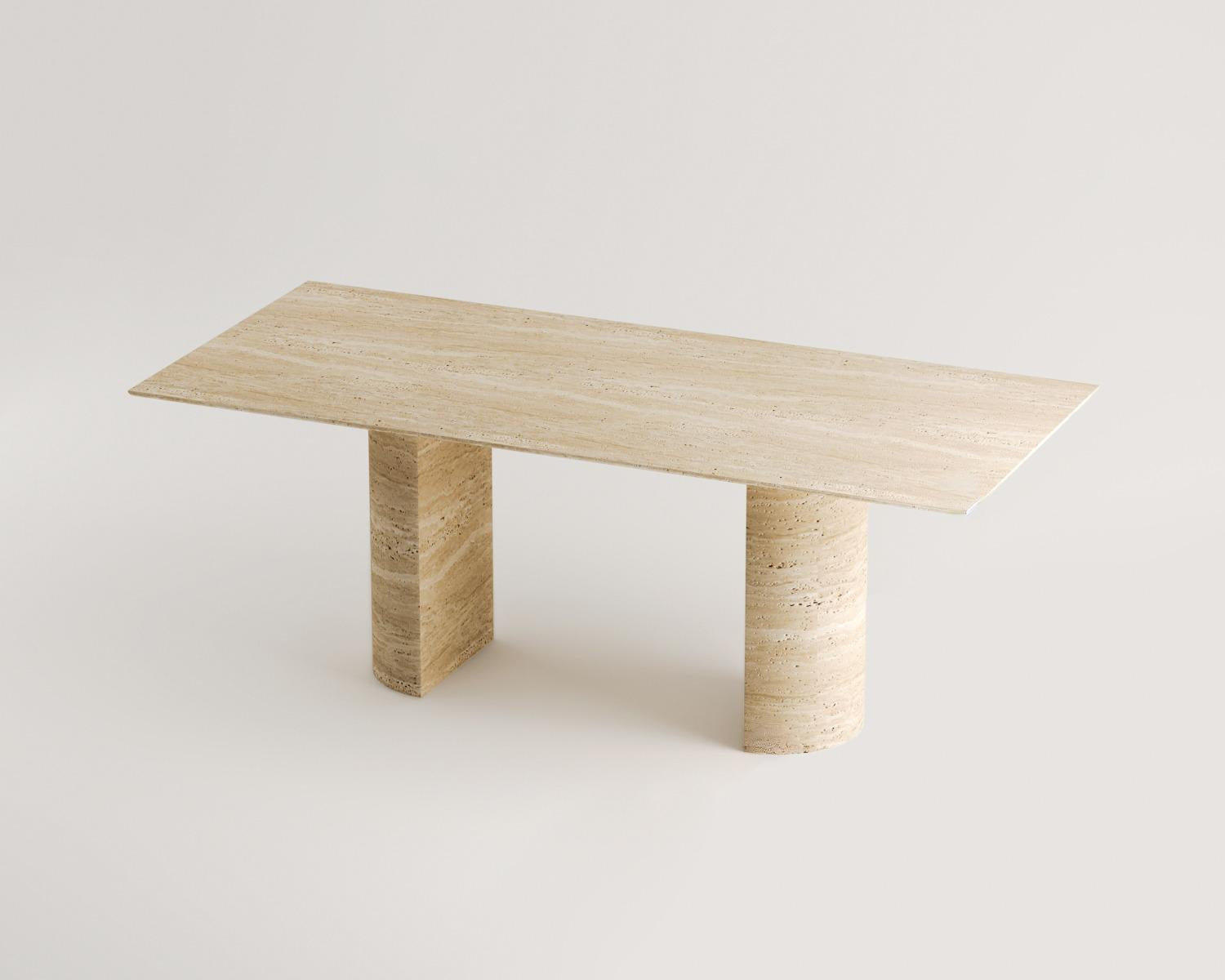 Luzione Vega dining table with travertine top and cylindrical legs. Modern stone furniture for luxury dining, showcasing unique patterns