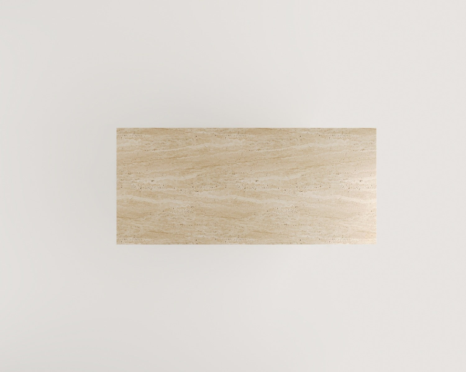 Top-down view of the Luzione Vega travertine table. A modern, minimalist stone furniture piece perfect as a coffee or side table in any living space.