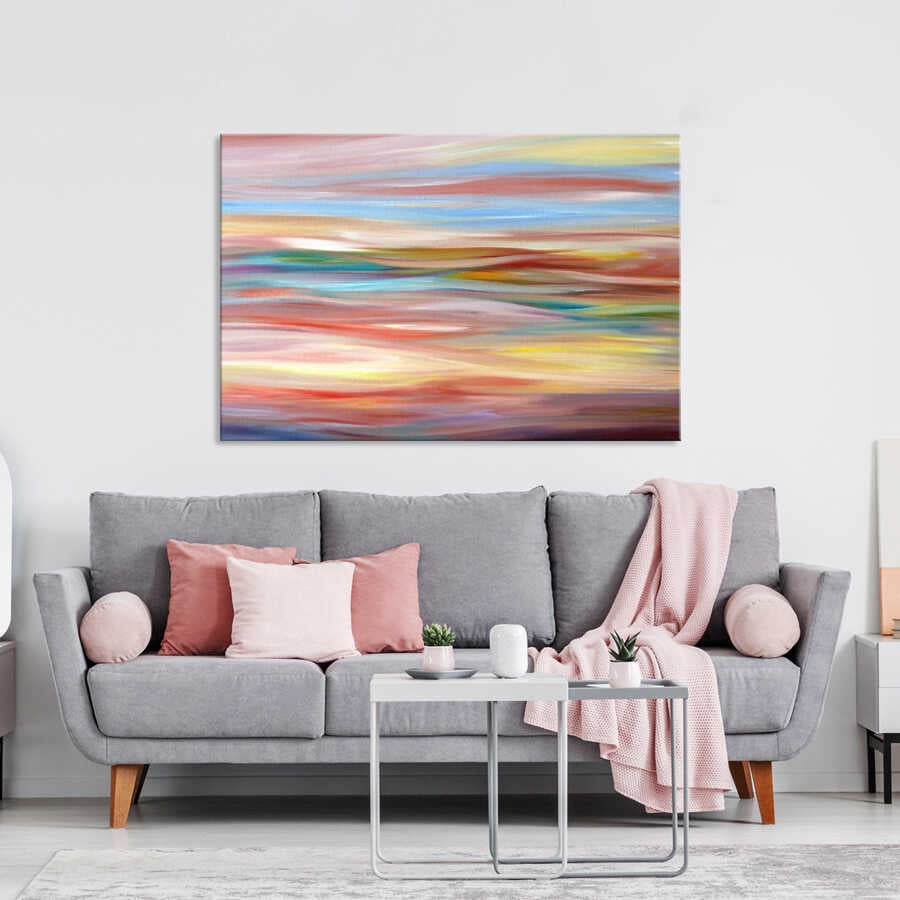 Living room with gray sofa, pink pillows, abstract painting, nesting tables