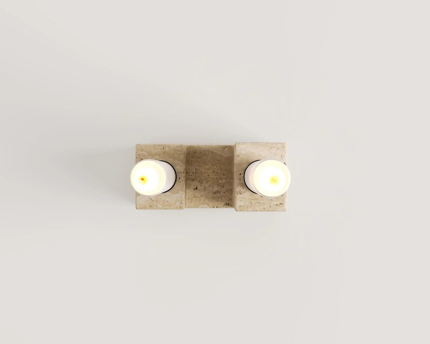 Travertine stone wall sconce lighting with two glowing bulbs