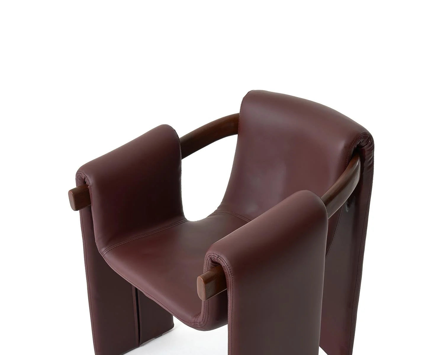 Close up of brown leather armchair with wooden frame