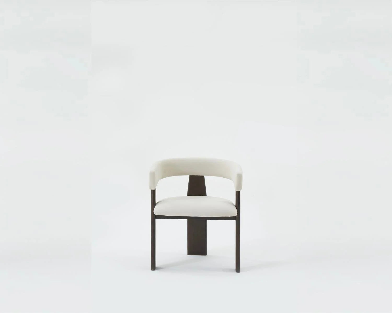Studio shot of white upholstered dining chair with dark wood frame