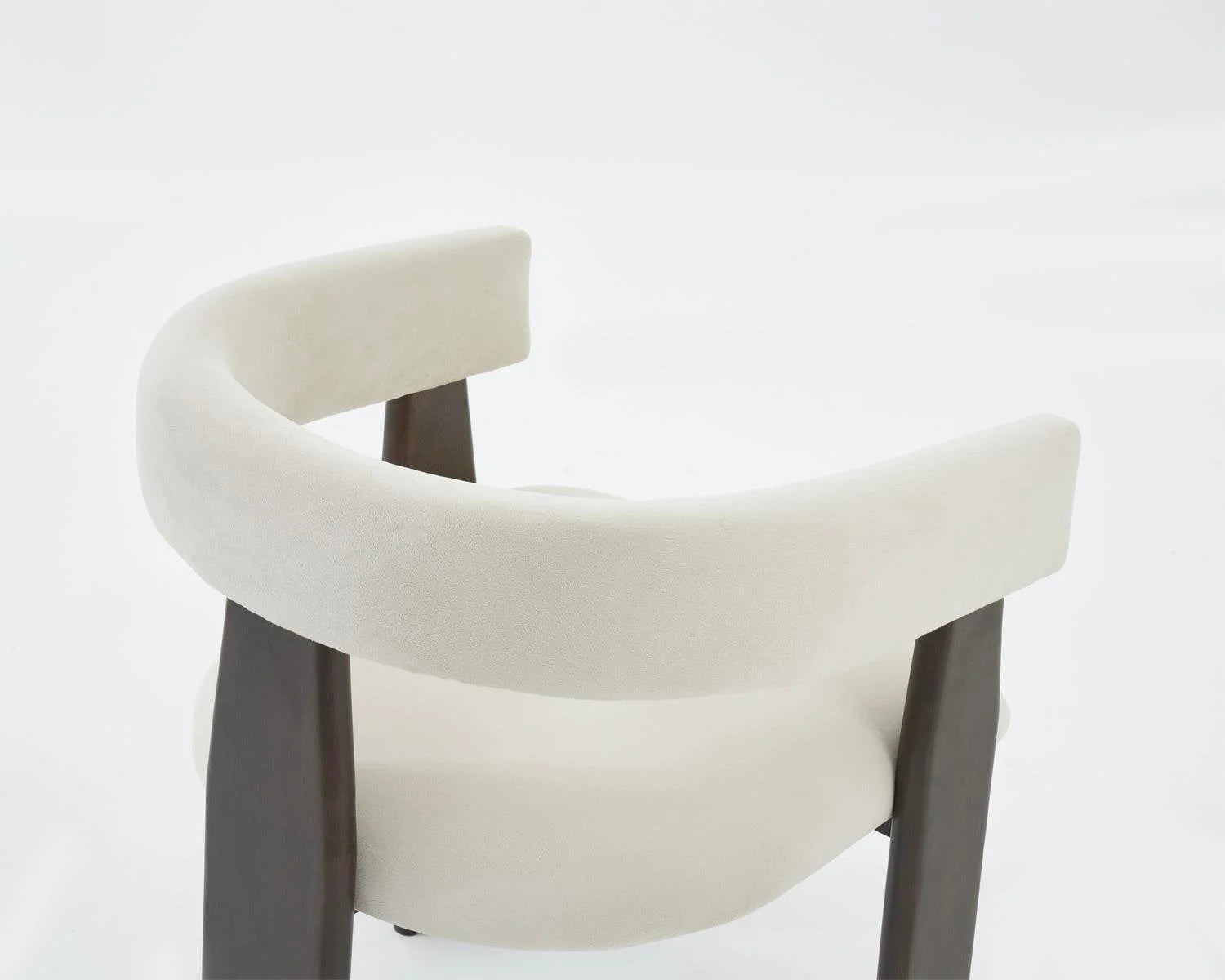 Close up view of cream upholstered chair with dark wood frame